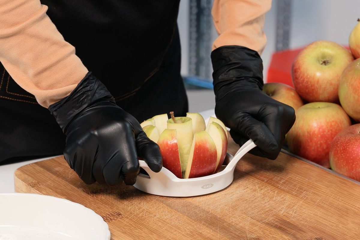person cutting an apple using the OXO apple corer slicer